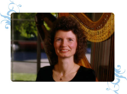 Dominique standing with her harp